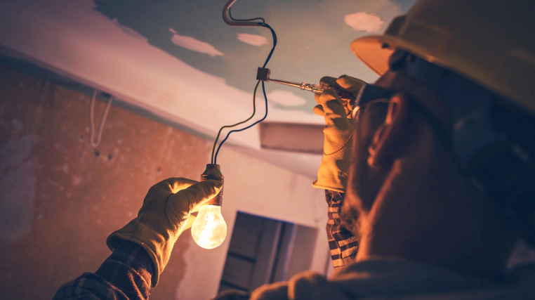electrician instaling a light bulb bellvue co